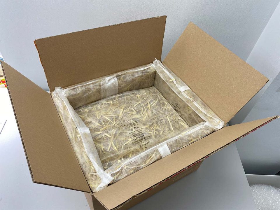 A photo of our new eco-shipping boxes that use straw panels for temperature insulation, replacing polystyrene boxes